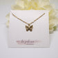 butterfly pendant necklace on white beaded chain